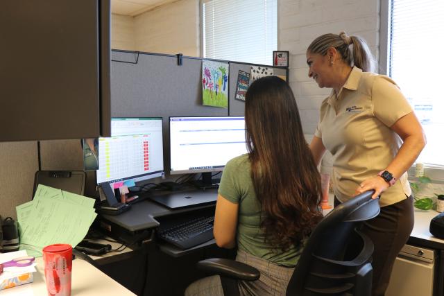 Two members of the WVWD billing team looking at computer screen
